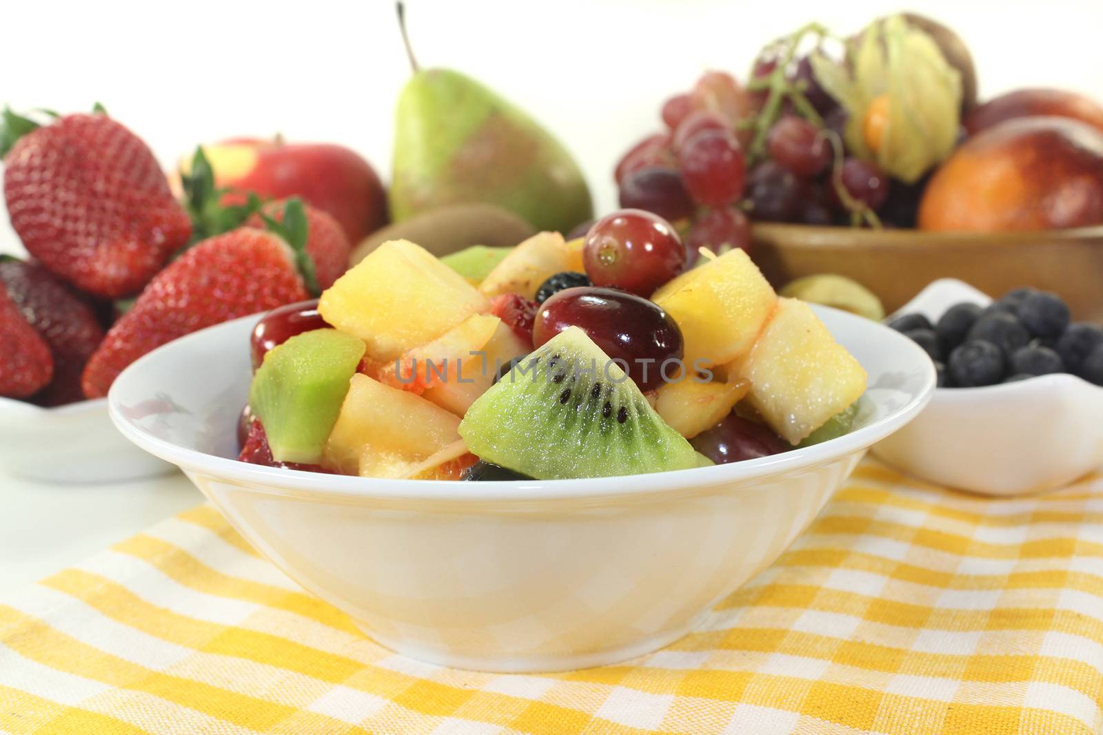 A white bowl with fresh fruit