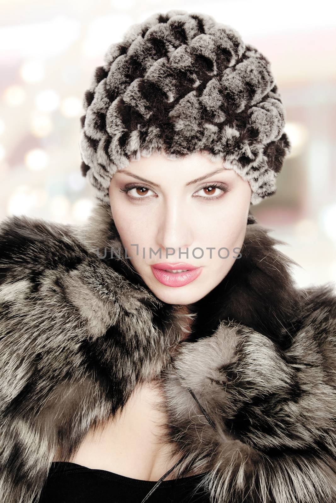 portrait of a beautiful youn woman with fur hat isolated on white