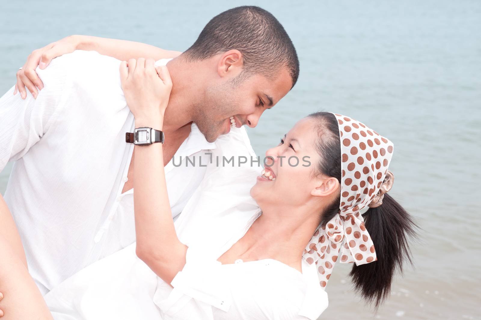 african man and asian woman lover on the beach