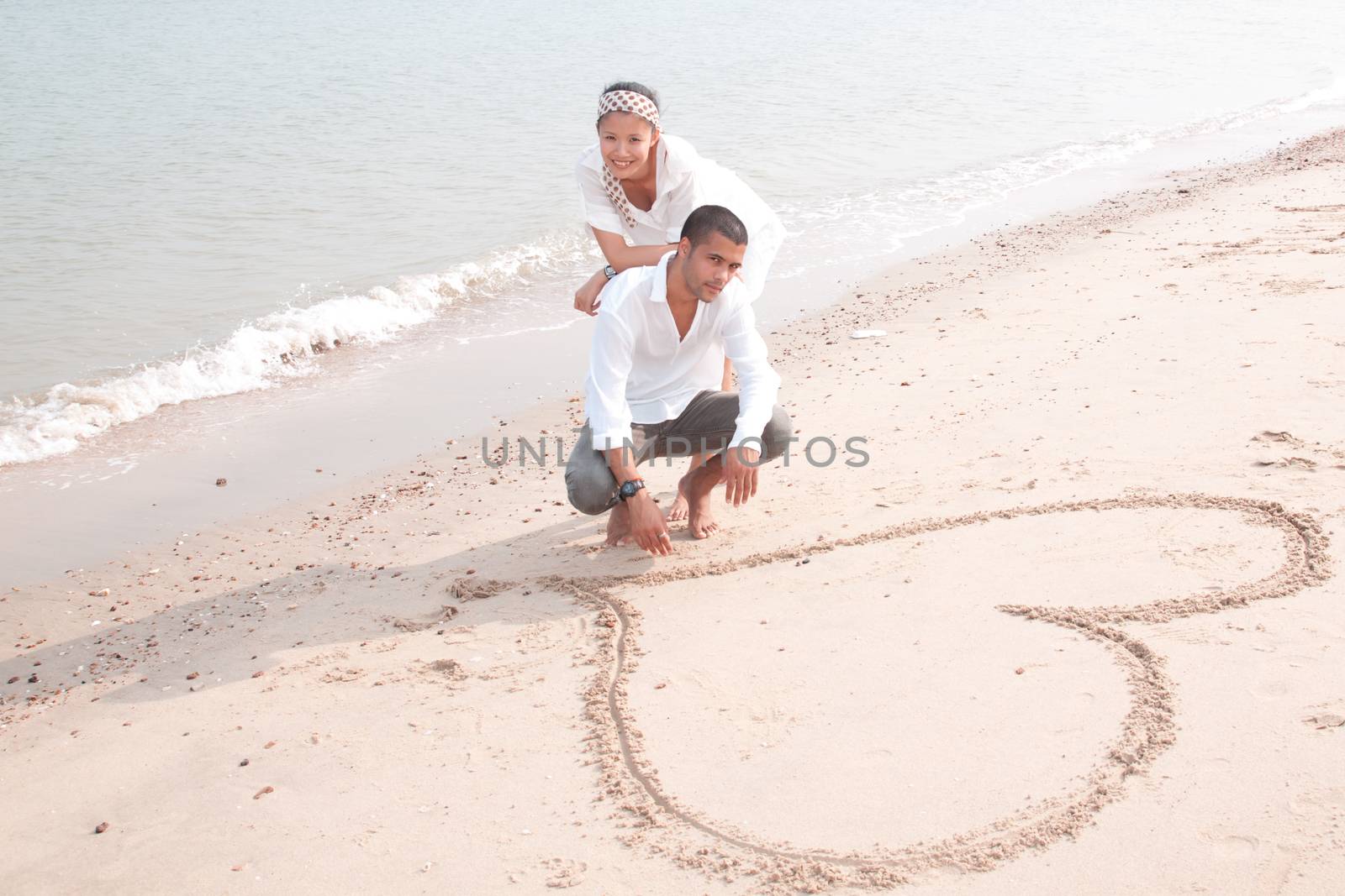 african man and asian woman lover on the beach