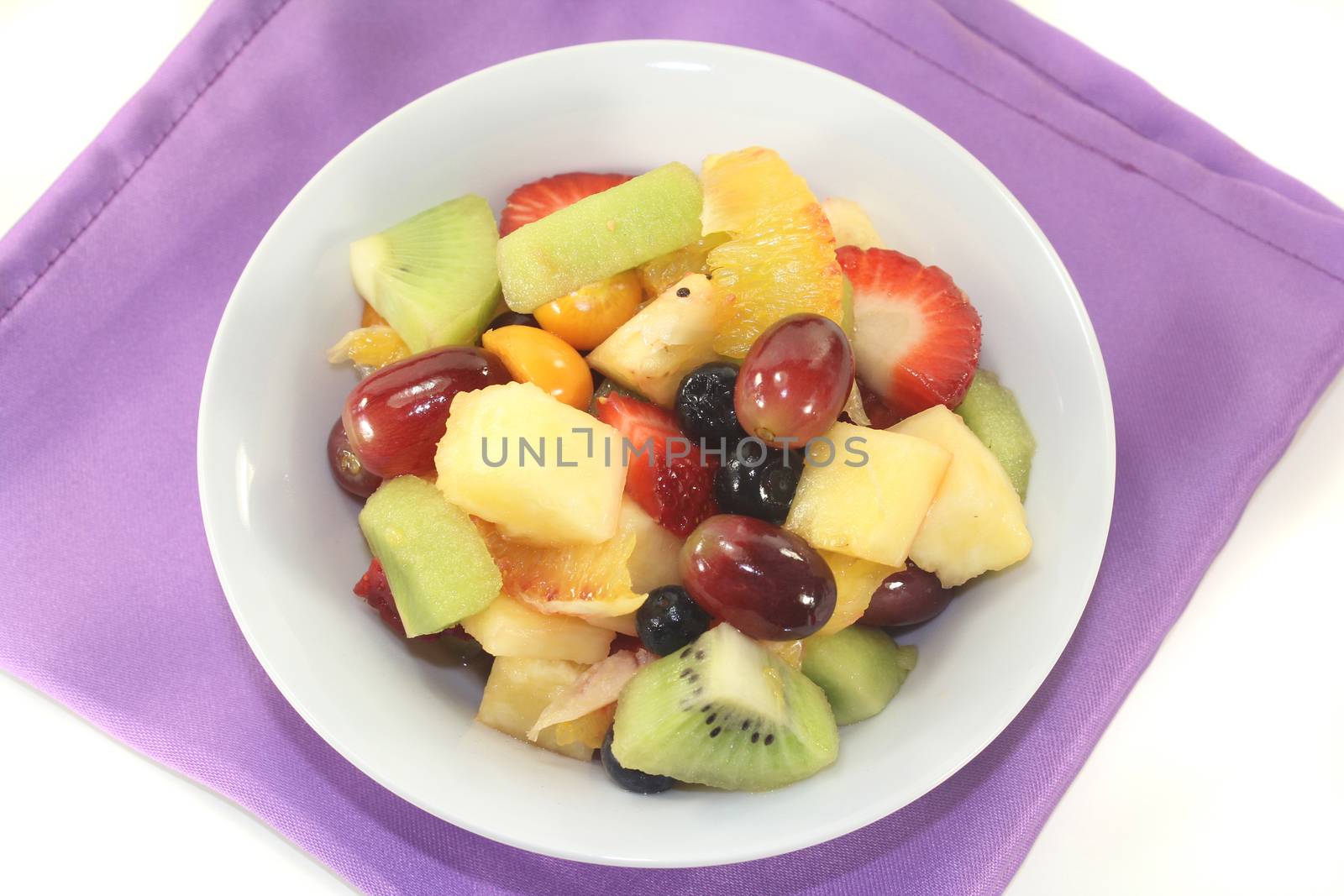 A white bowl with fresh fruit