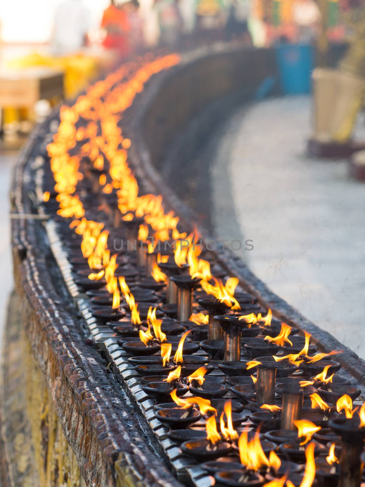 Burning oil lamps at the Shwedagon Pagoda in Yangon, the capital of Republic of the Union of Myanmar. Shallow depth of field.