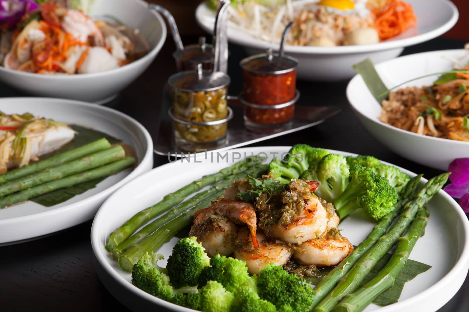 Shrimp scampi seafood dish with broccoli and asparagus.