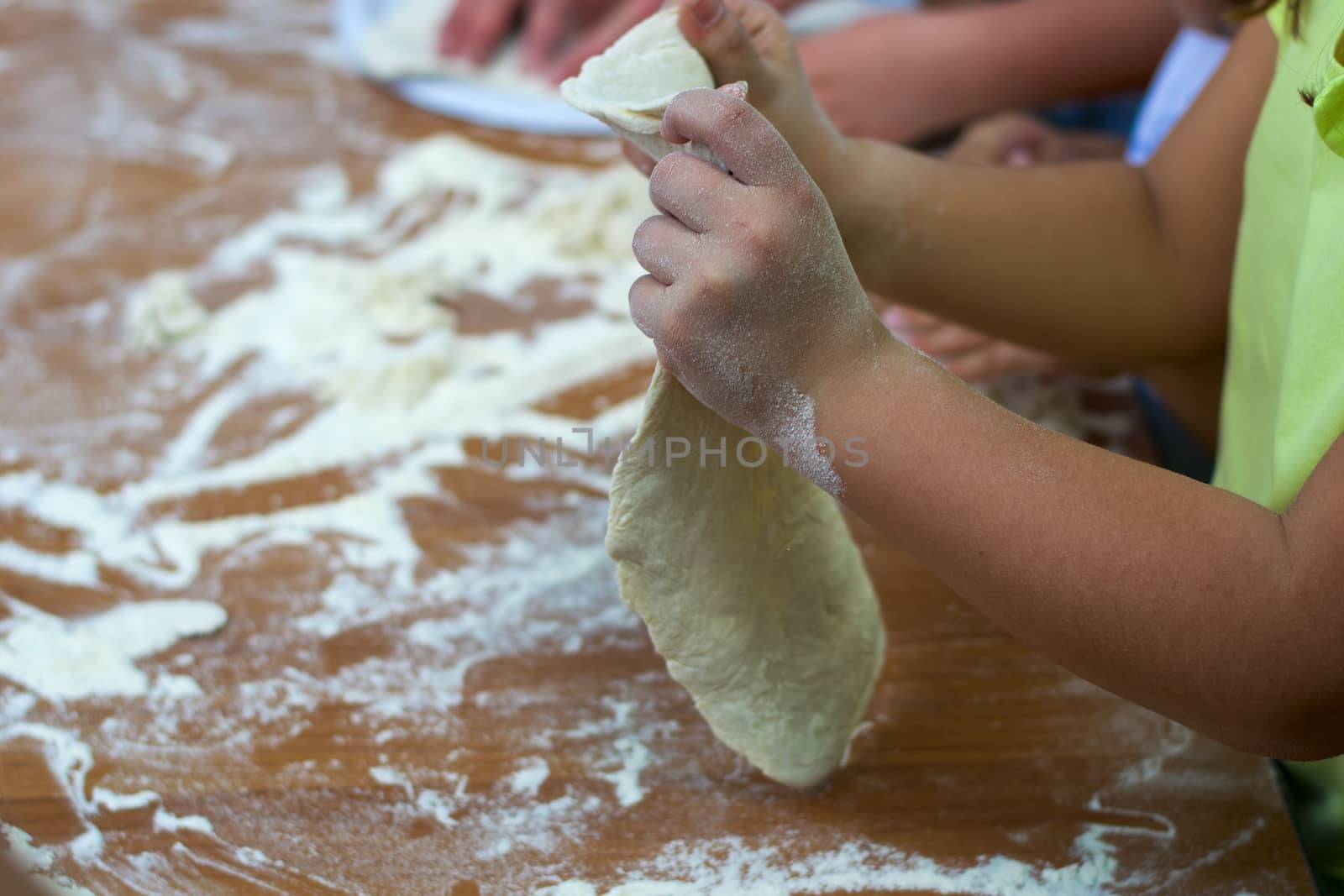 Group of children preparing pizza