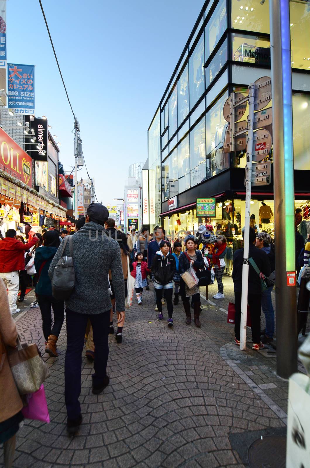TOKYO - NOV 24 : People, mostly youngsters, walk through Takeshita Dori near Harajuku train station on November 24, 2013. Takeshita Dori is considered a birthplace of Japan's fashion trends. 