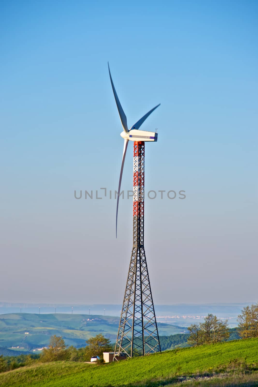 Wind turbine tower over the hills