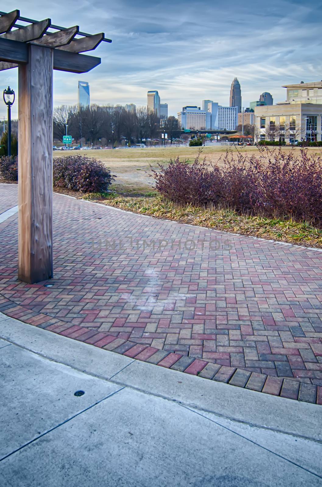 cultured stone terrace trellis details near park in a city 