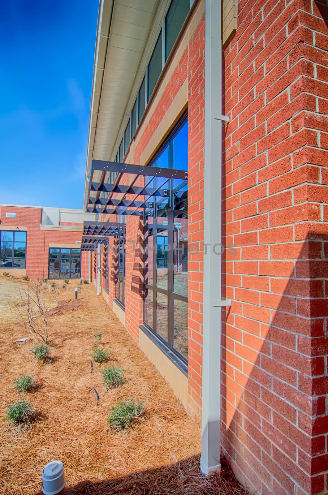 brick building architecture with suncreen shades on windows