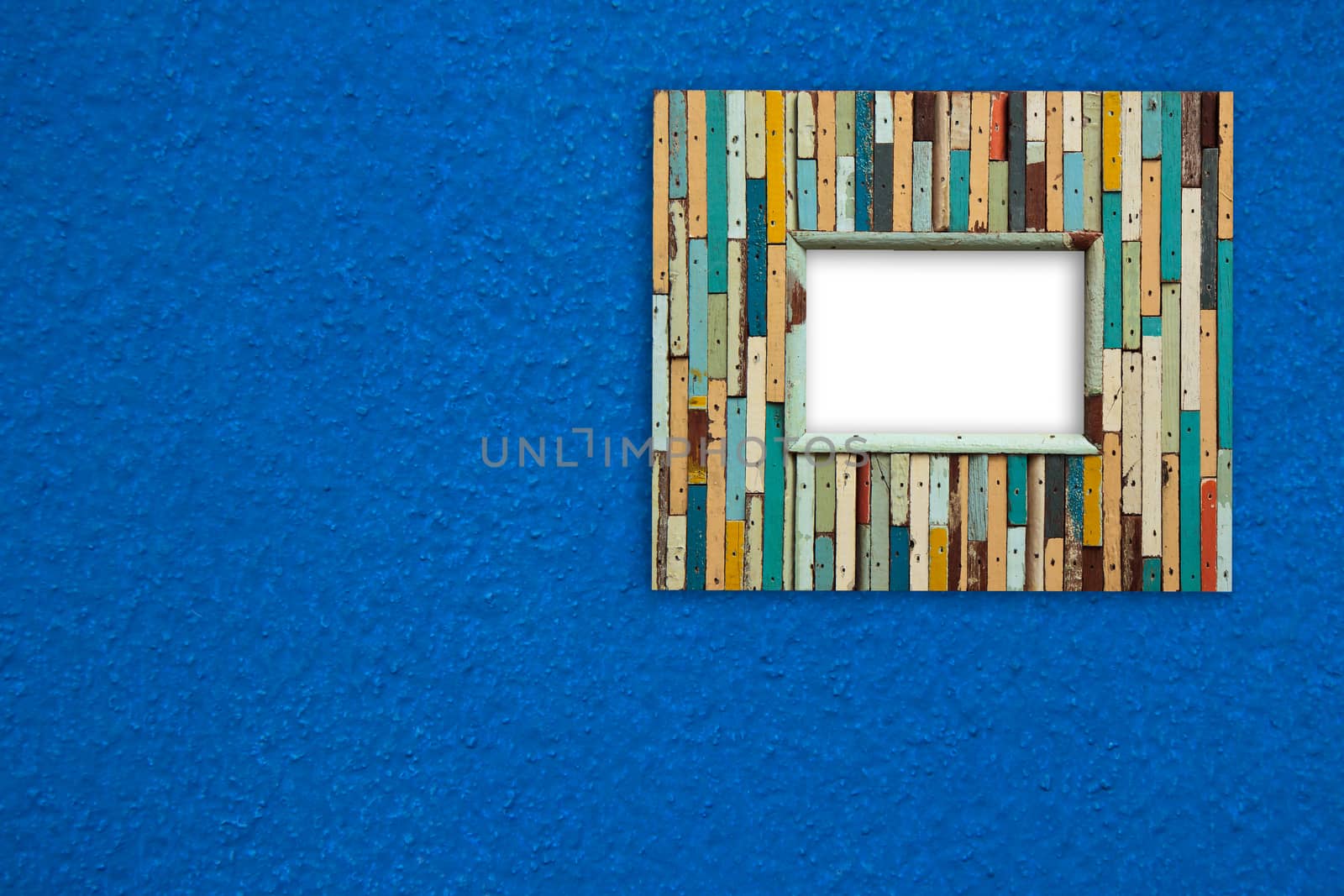 old colorful wooden frame on blue wall