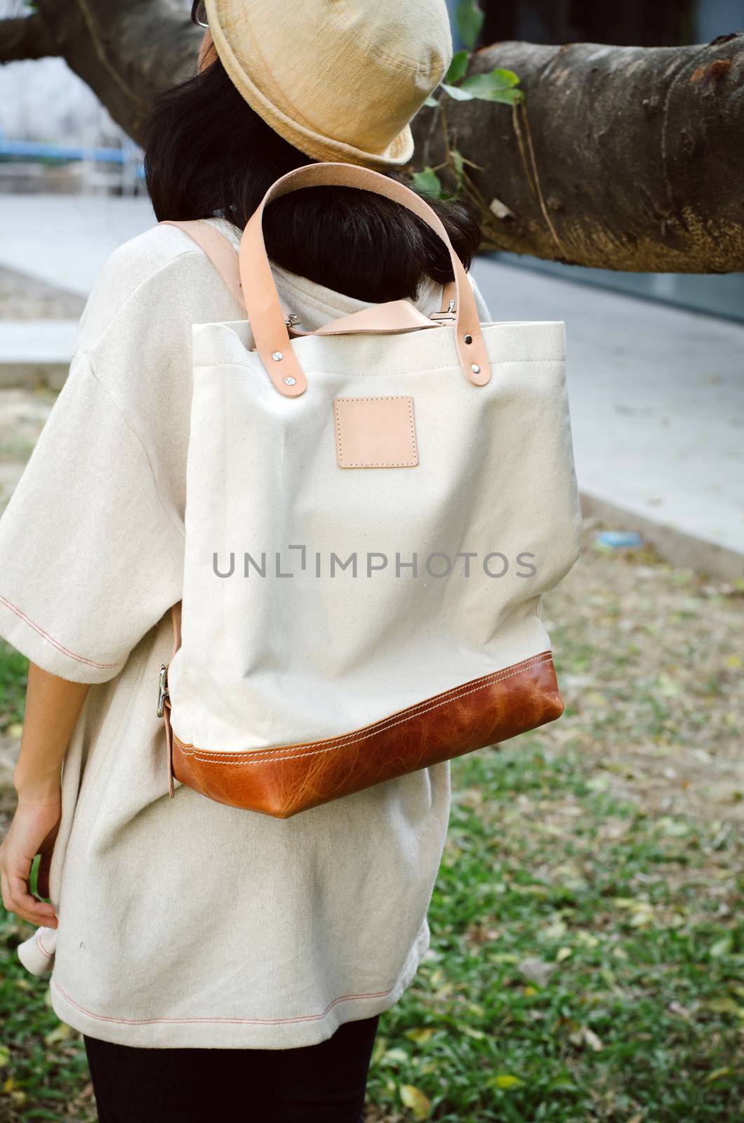 Young woman with a canvas bag by siraanamwong