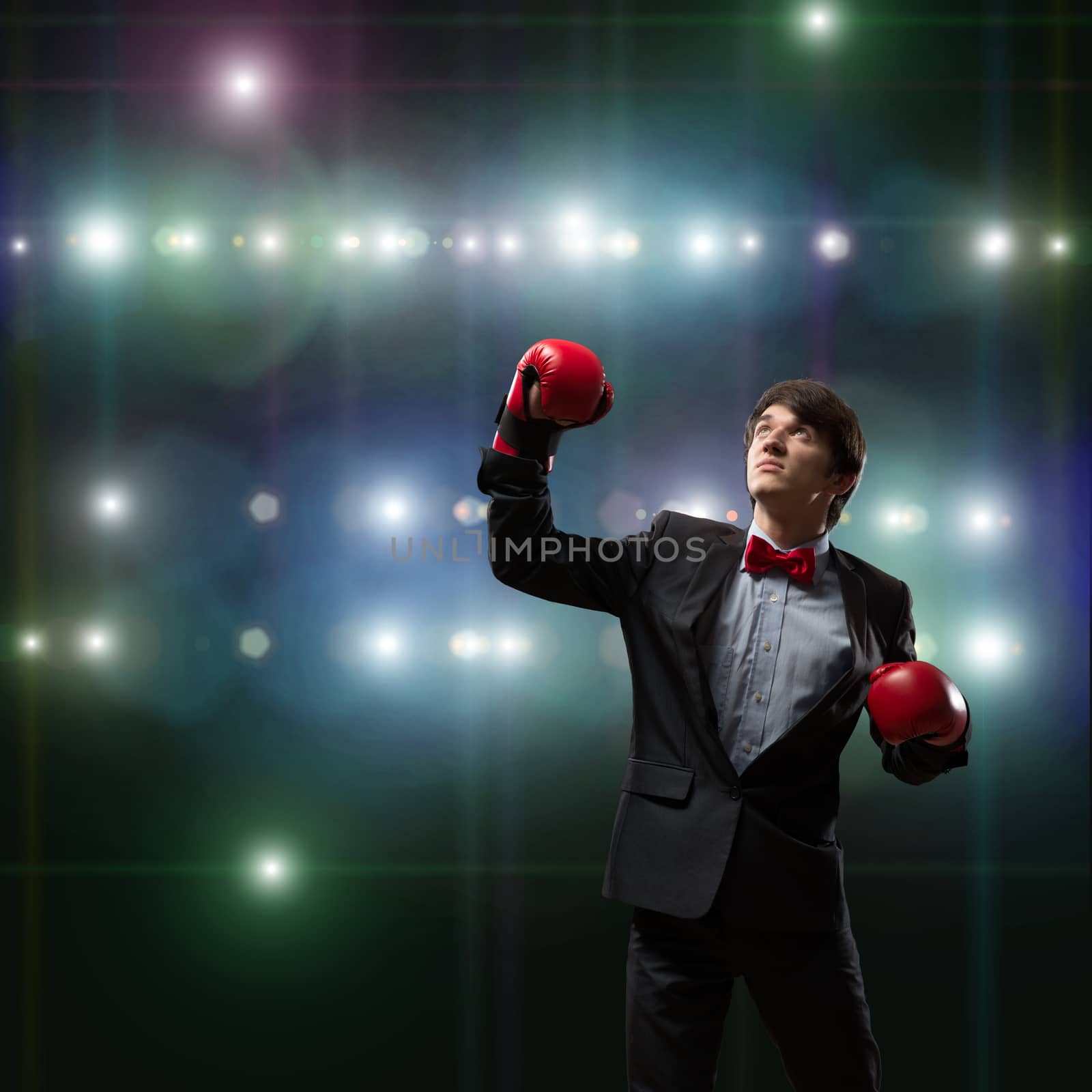 image of a businessman with boxing gloves in the ring, the competition in the business