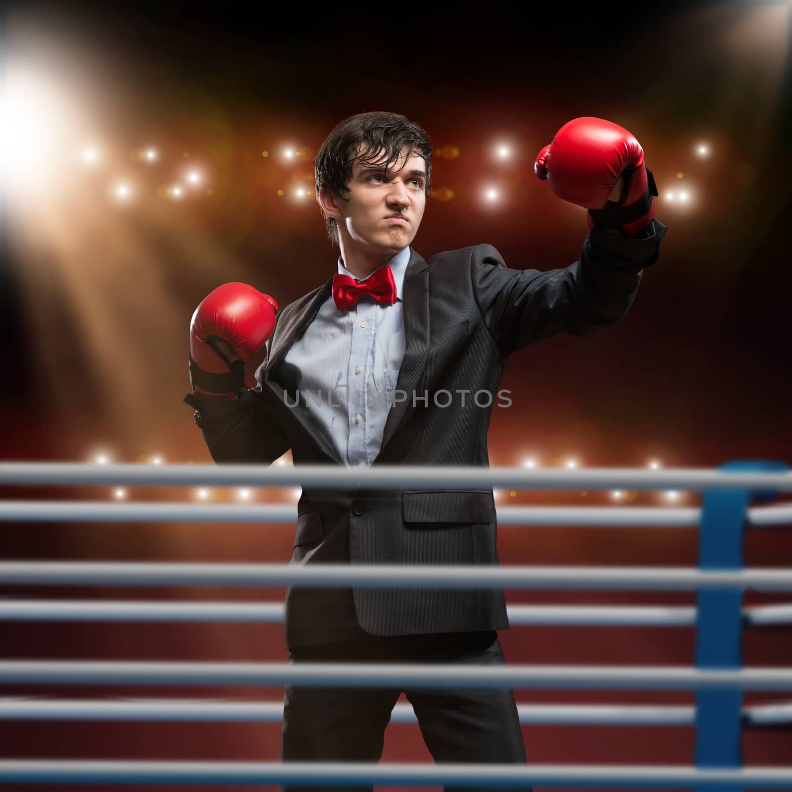 image of a businessman with boxing gloves in the ring, the competition in the business