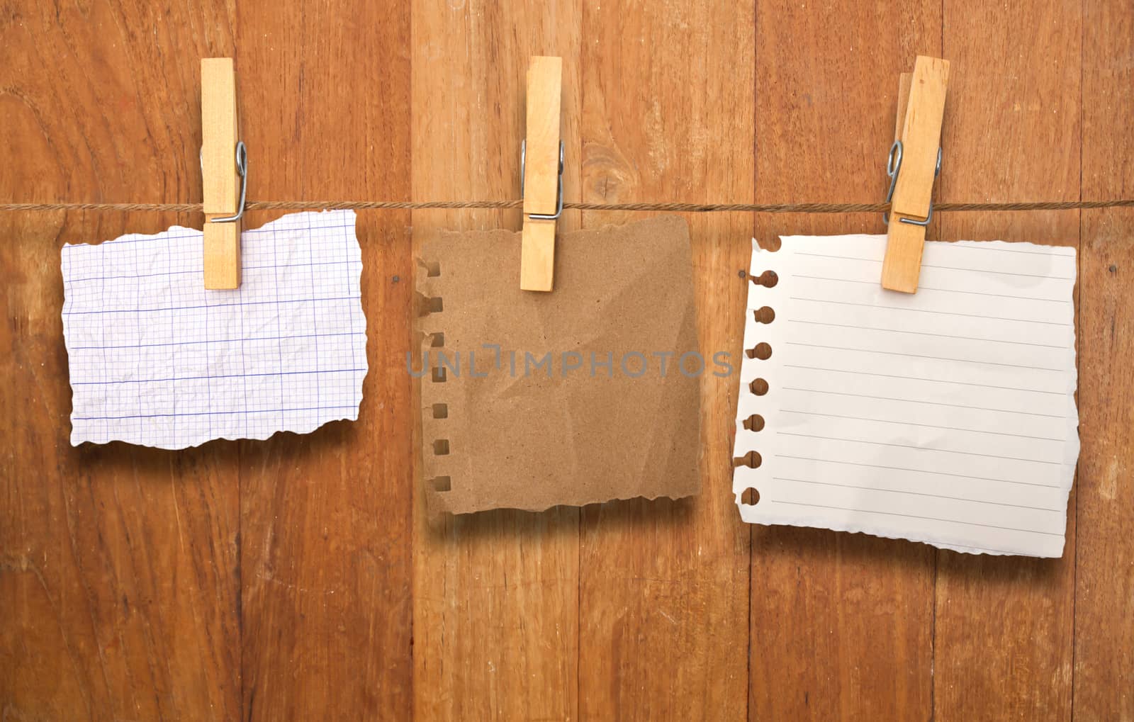 close up of a notes and a clothes pegs on wood wall