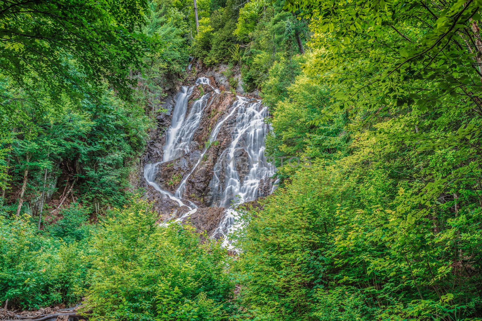 An amazingly clear waterfall in the wild nature in the forests of Ontario, Canada.