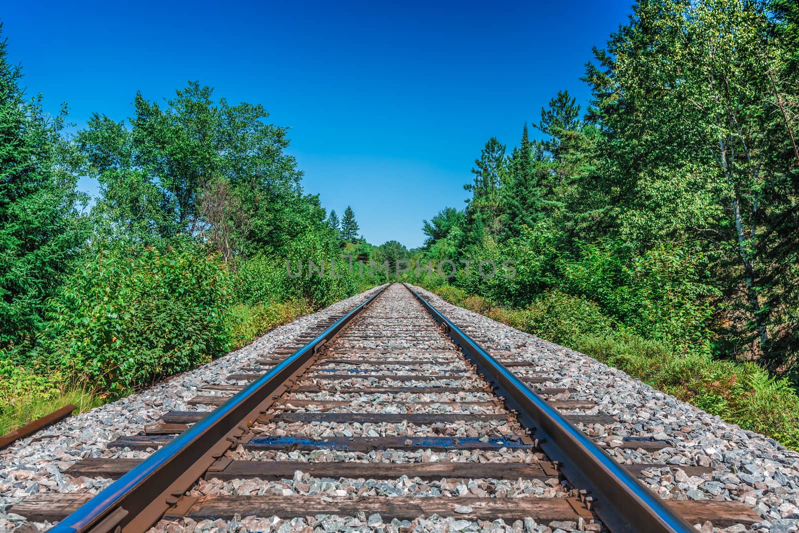 An amazing view of a really long railway on a sunny day. Canada.