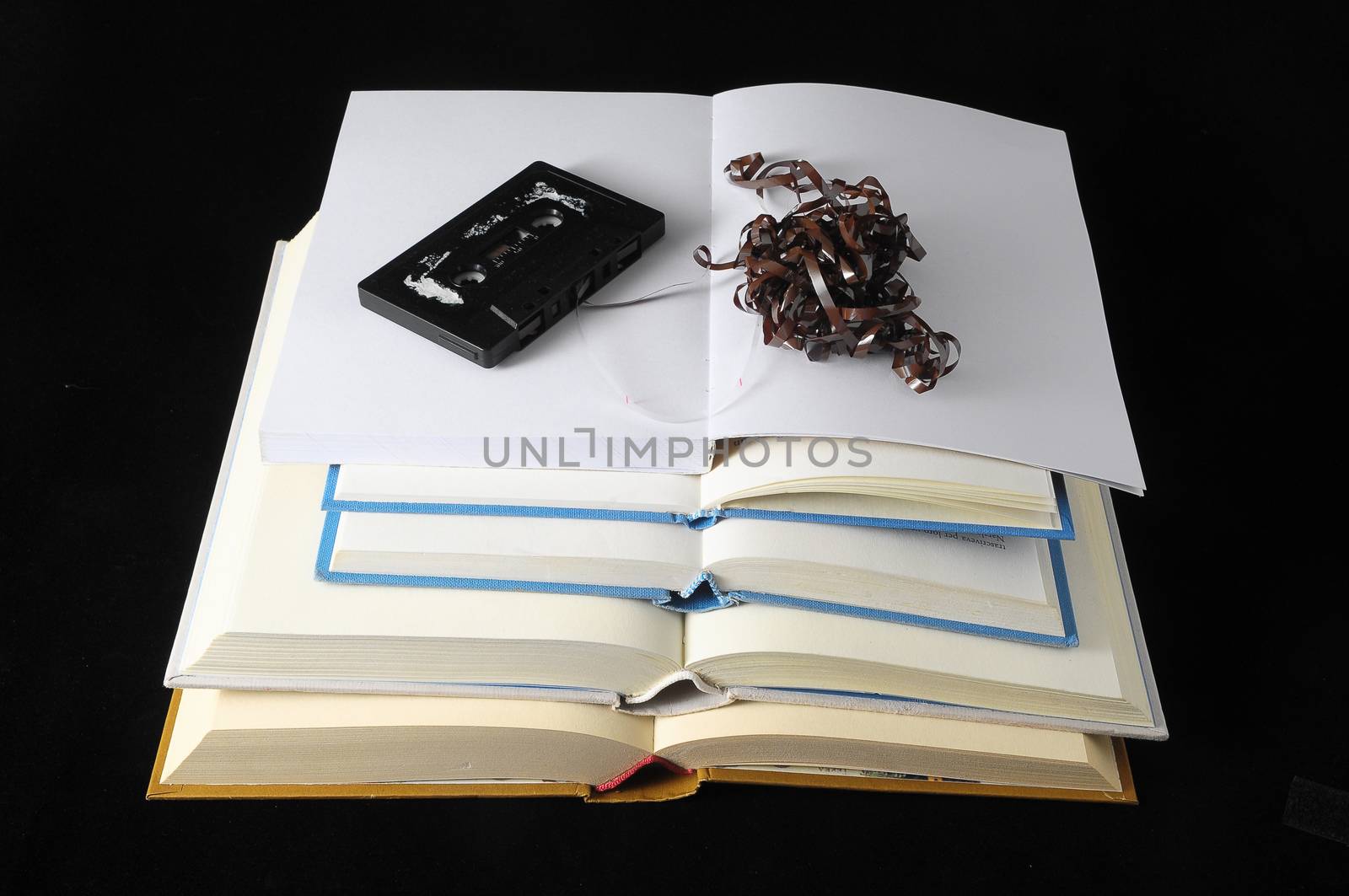 Empty Classic Book and Music Tape Isolated over a Black Background