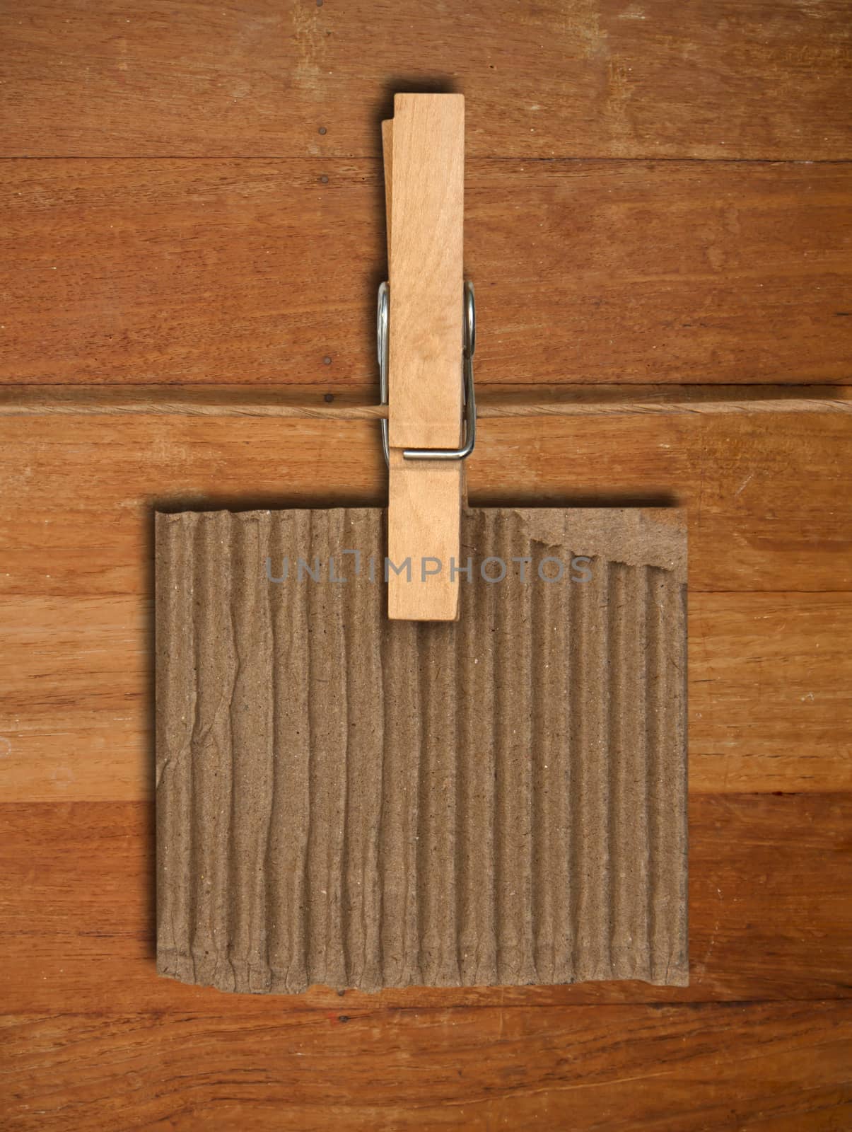 close up of a notes and a clothes pegs on wood wall