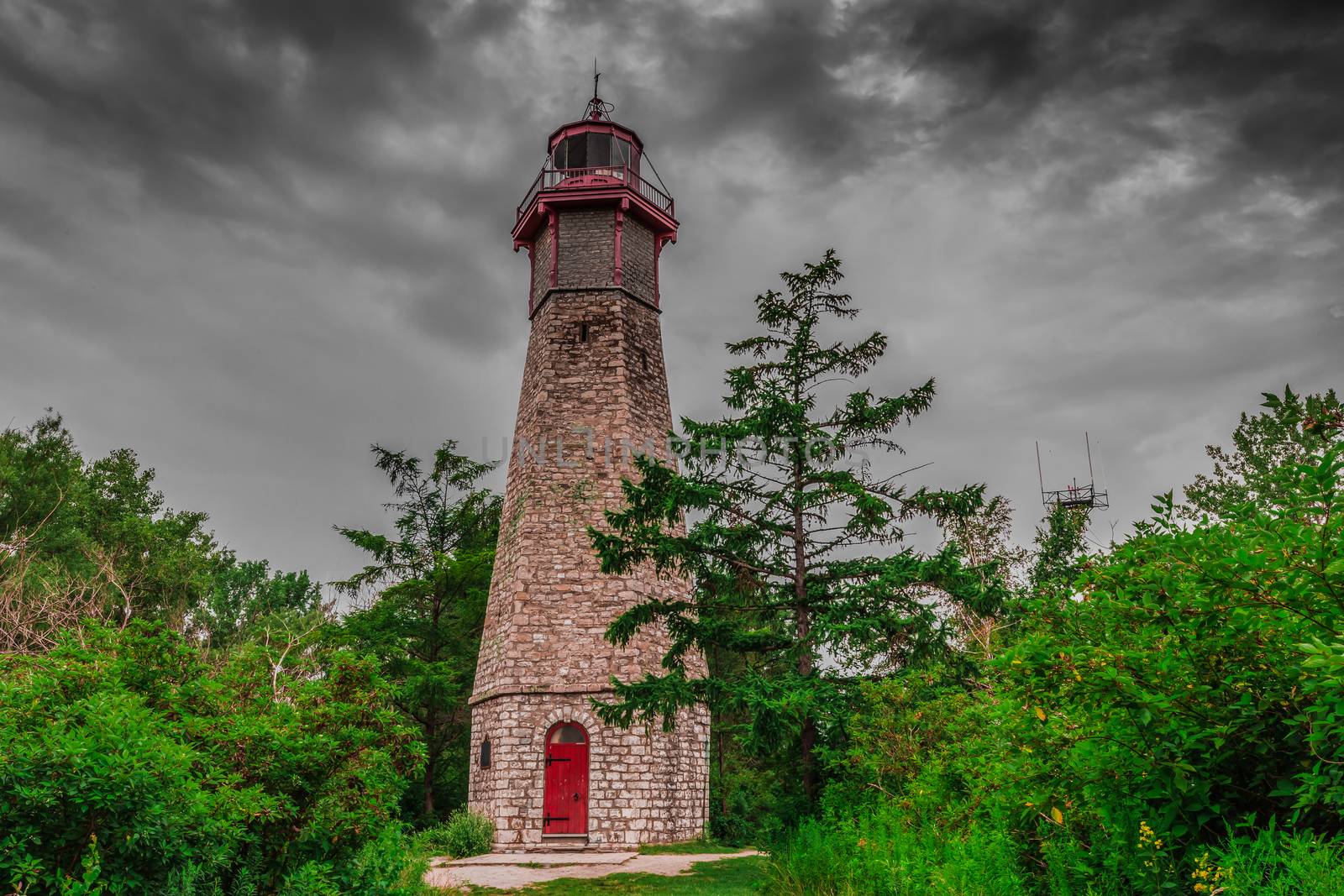 An abandoned lighthouse in a cloudy day by petkolophoto