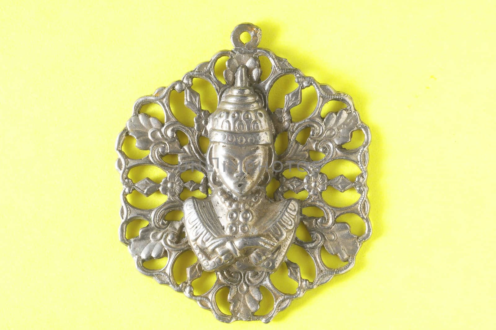 Silver Buddha Pendant Jewel over a Colored Background