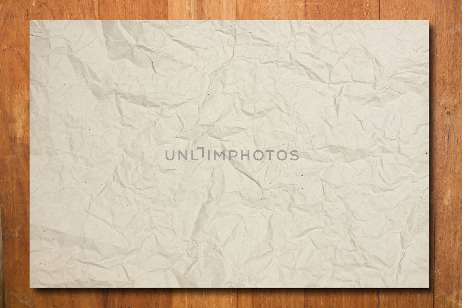 Crumpled paper on wood wall