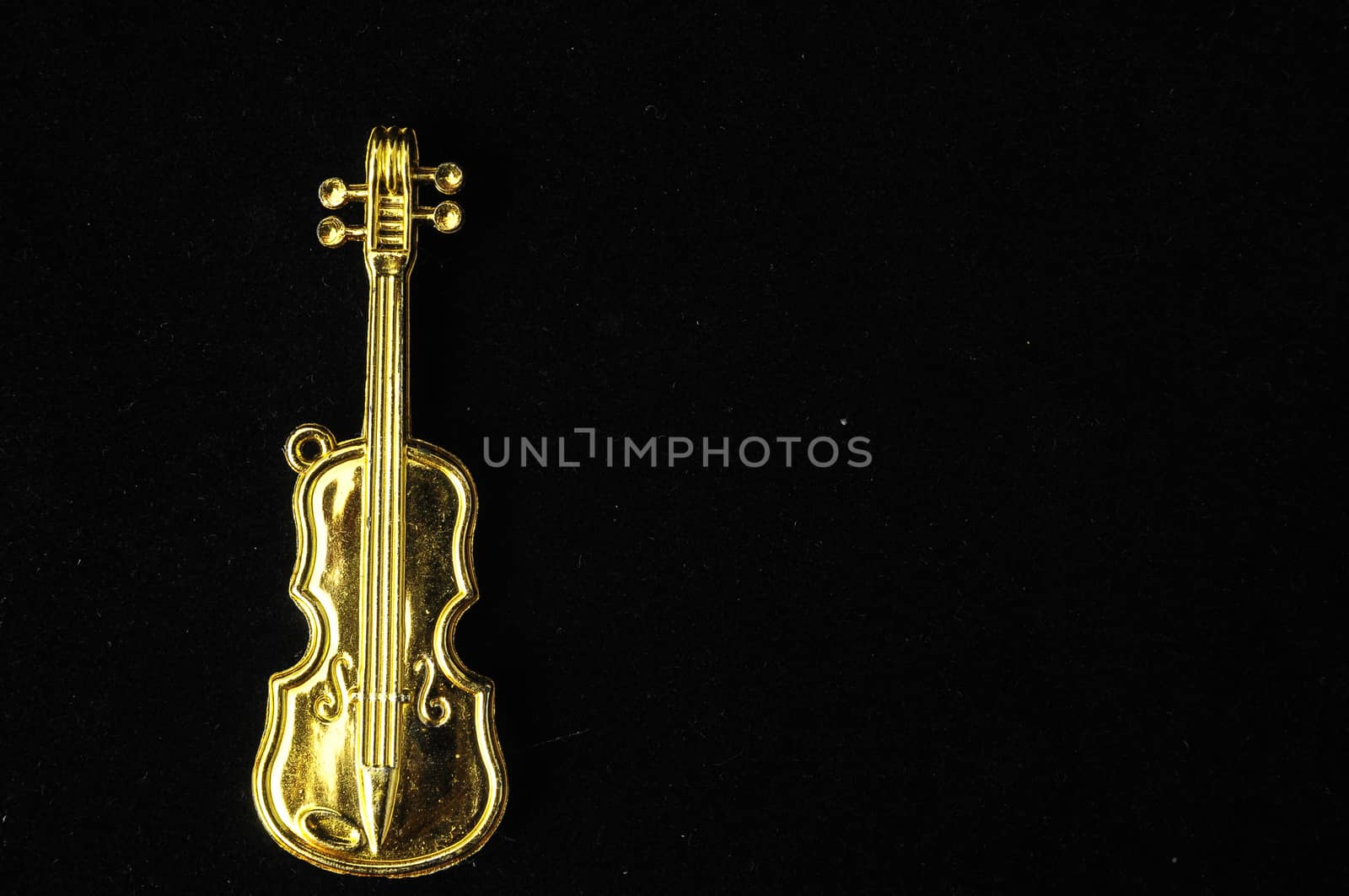 Gold Violin Instrument Figurine on a Colored Background