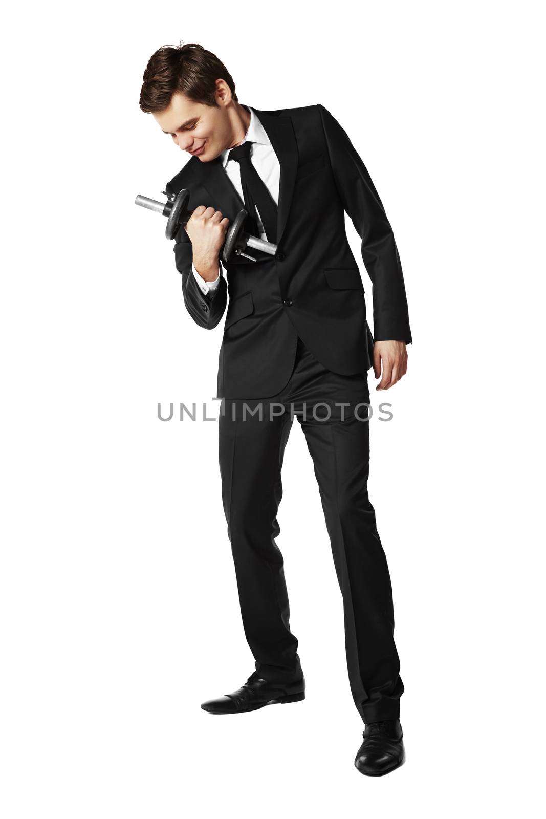 Young businessman picking up the dumbbell.