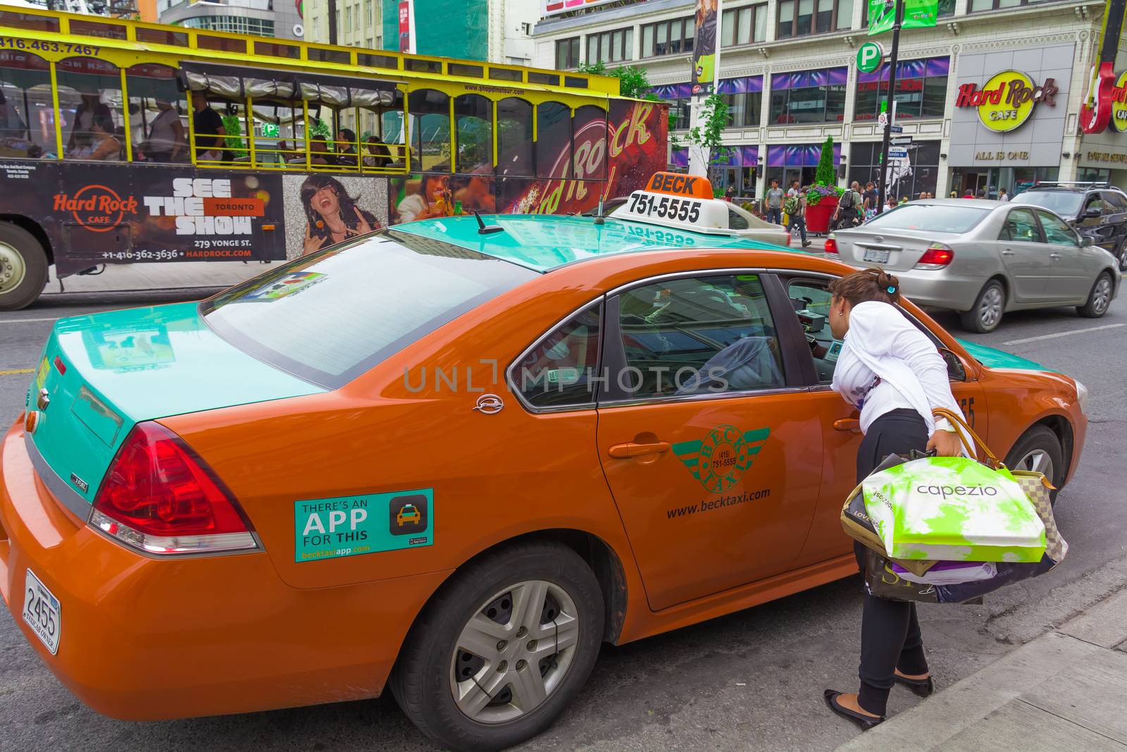 A woman taking a taxi by petkolophoto