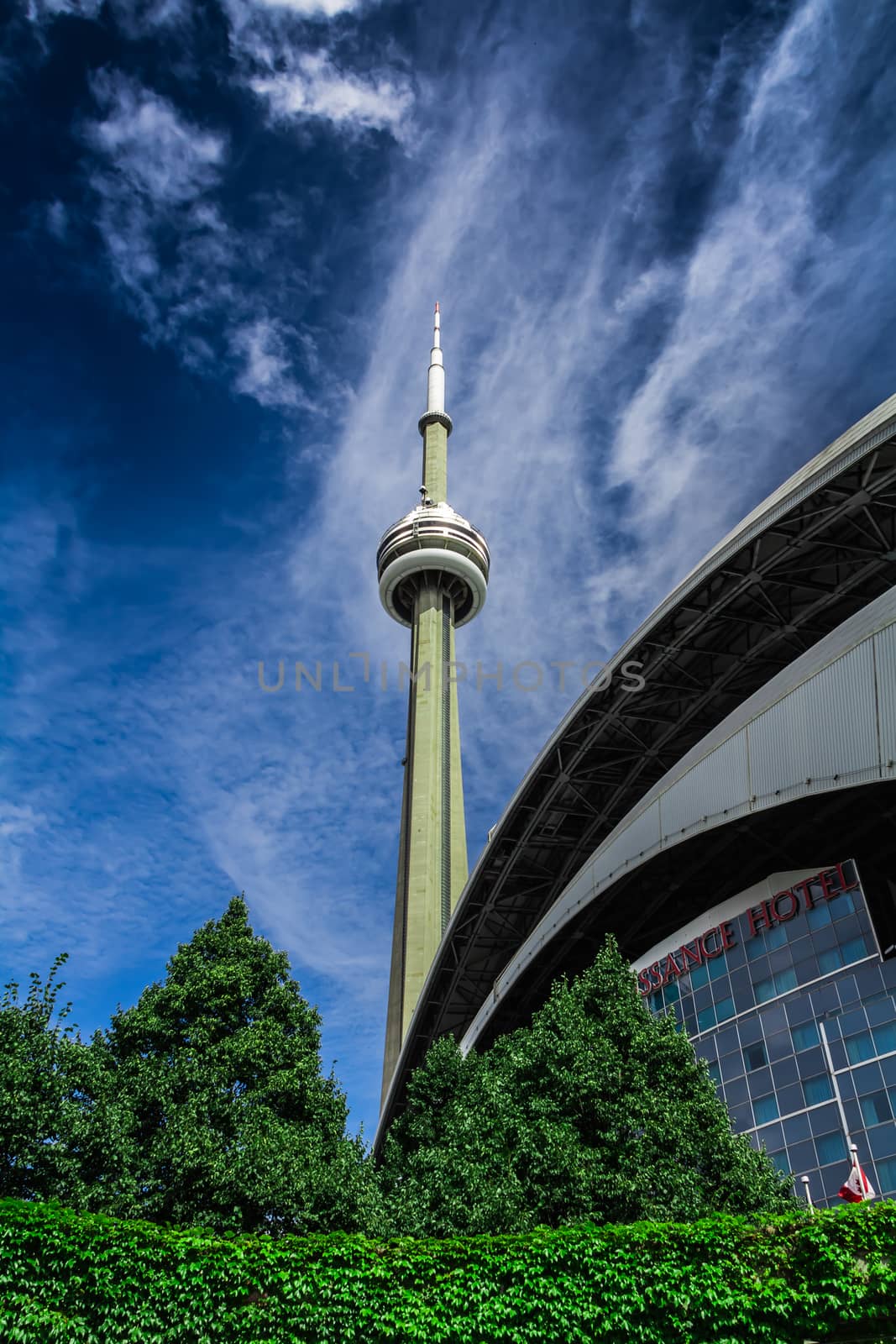 The CN Tower on a blue sky background in beautiful day. Its location is in Toronto, Canada.