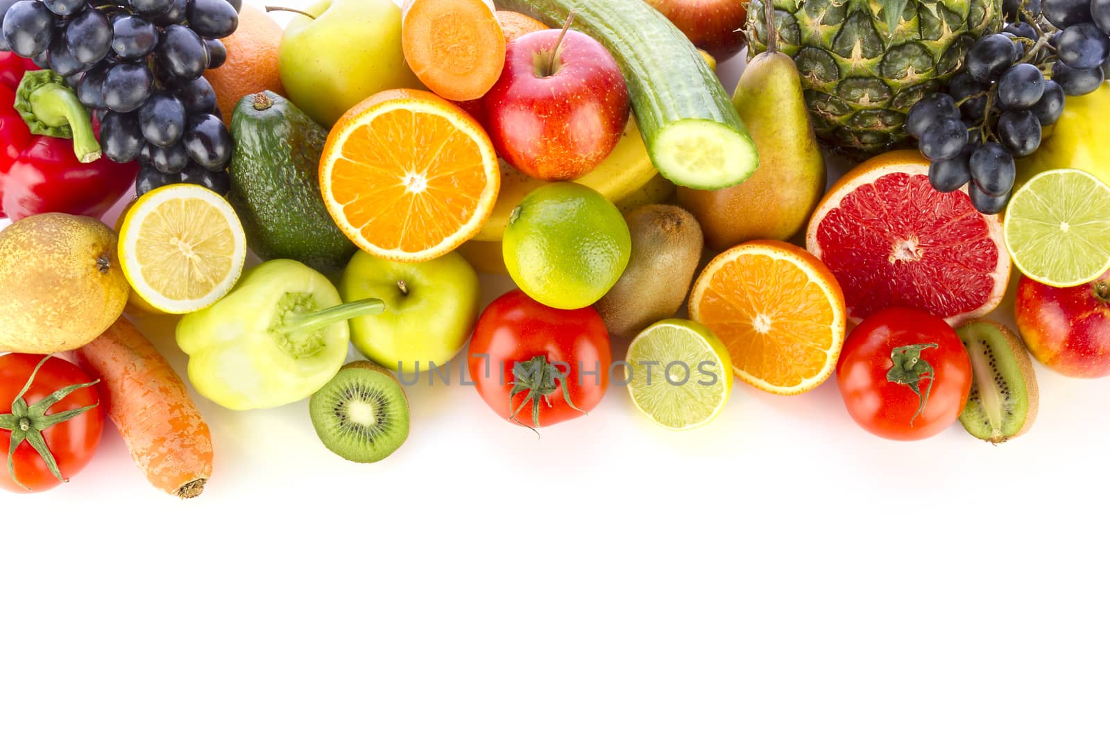 A pile of fresh, healthy fruits and vegetables on white.
