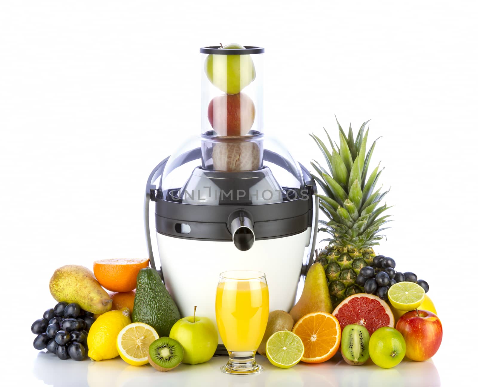 Fresh fruits and glass with juice near withe juicer on white background. Healthy fruits eating and drinking.
