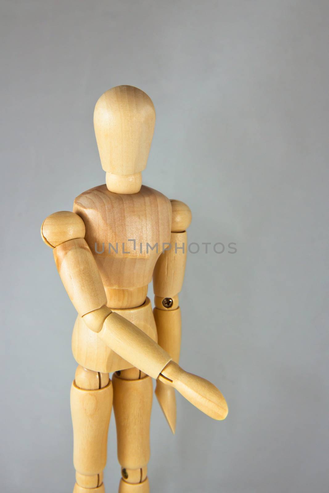 A wooden mannequin give a hand, greets. isolated