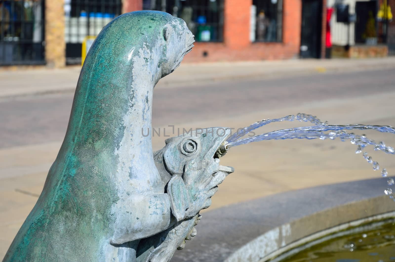 Statue of otter with fish by pauws99