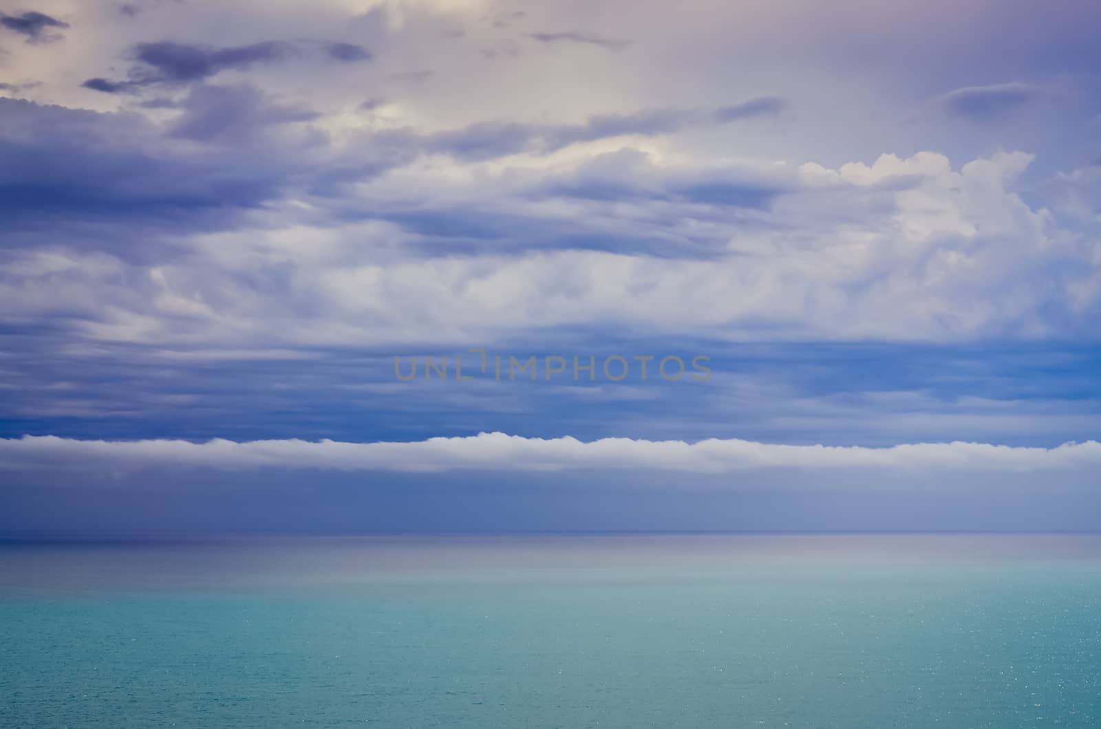 Scenic view of ocean and dramatic cloudscape colors