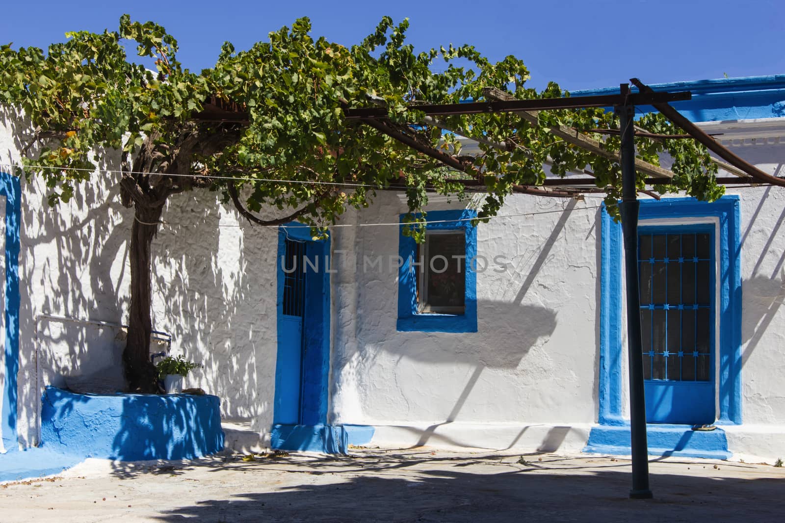 White house with lush vegetation from Greece