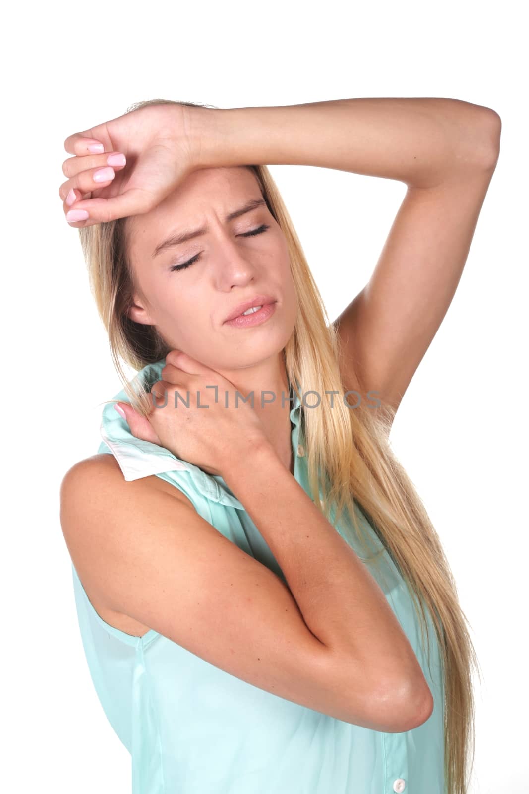 Young lady with migraine headache and sore neck with hand on forehead