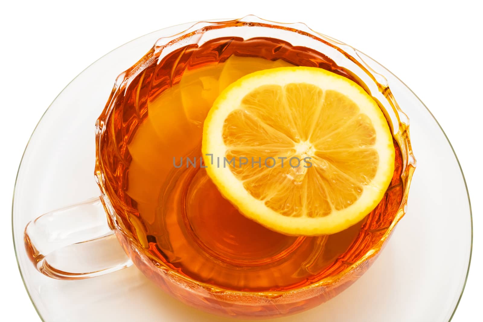 glass cup with tea and a lemon on a white background