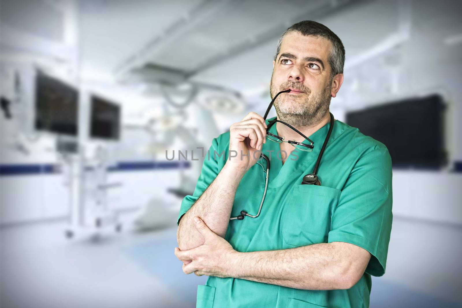 Smiling doctor with arms crossed in hospital by digicomphoto