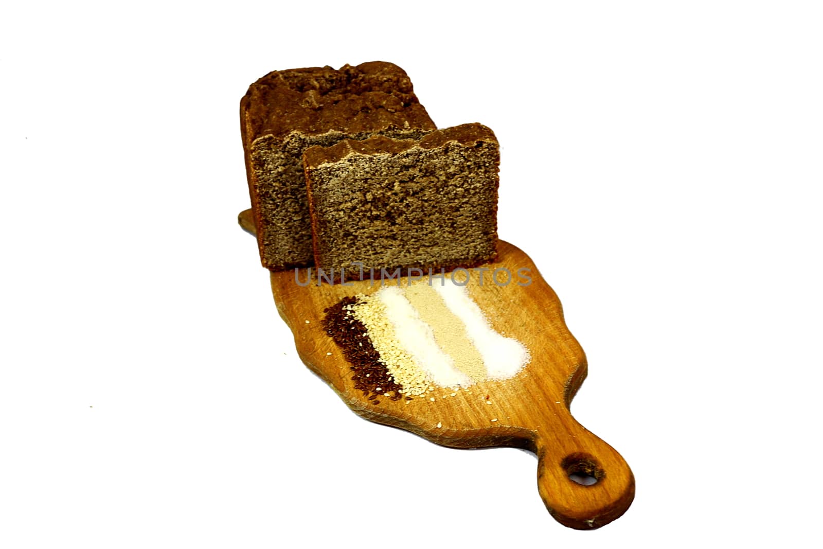 Tablet on a white background, brown bread, salt, sugar, sesame seeds, yeast and flax seeds