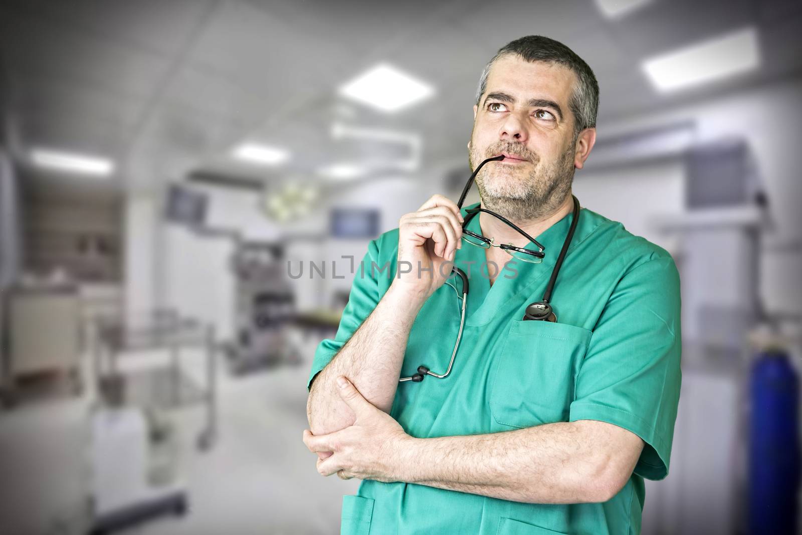 Smiling doctor with arms crossed in hospital by digicomphoto