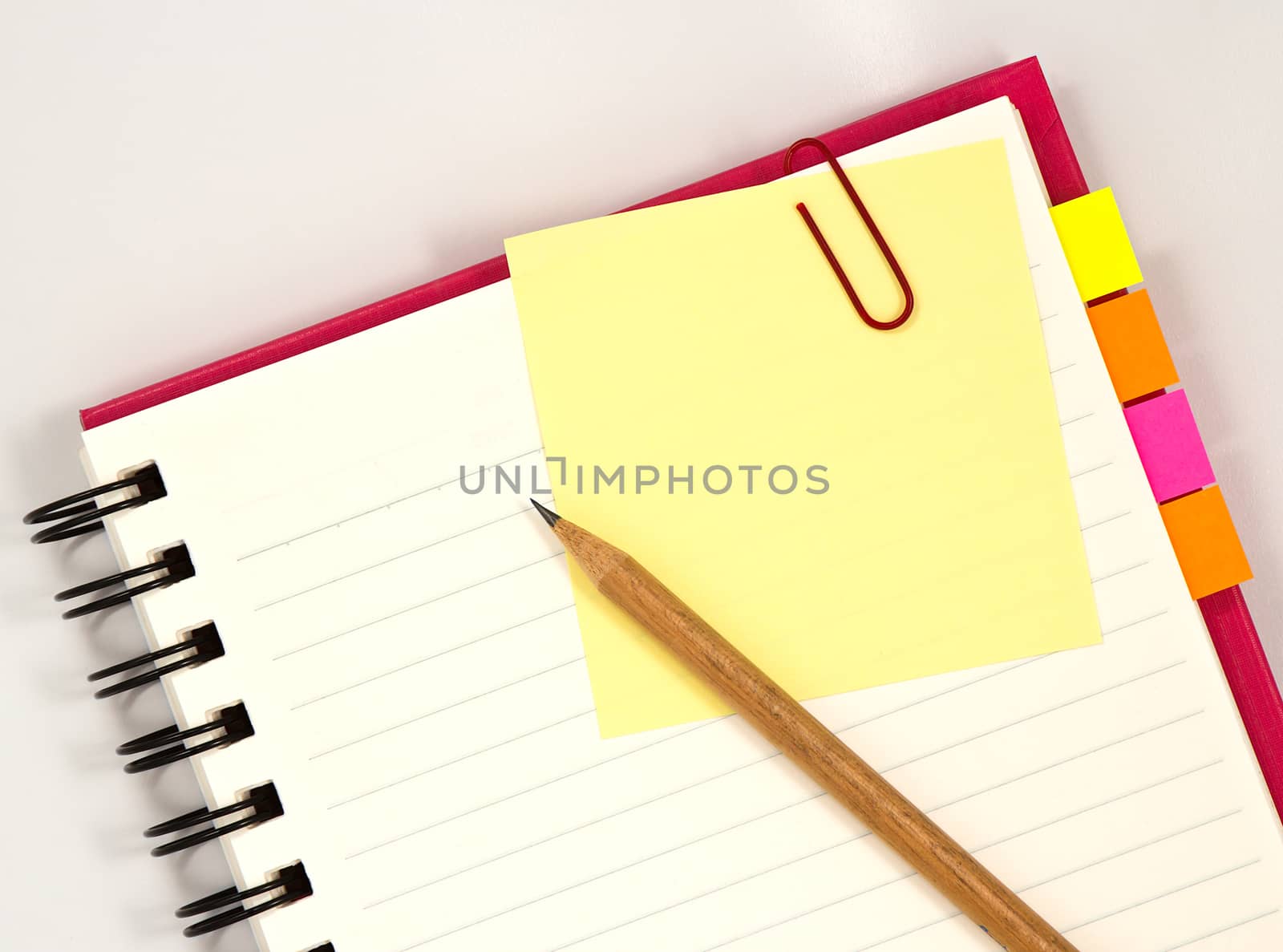 Red notebook with notepad isolated on white background
