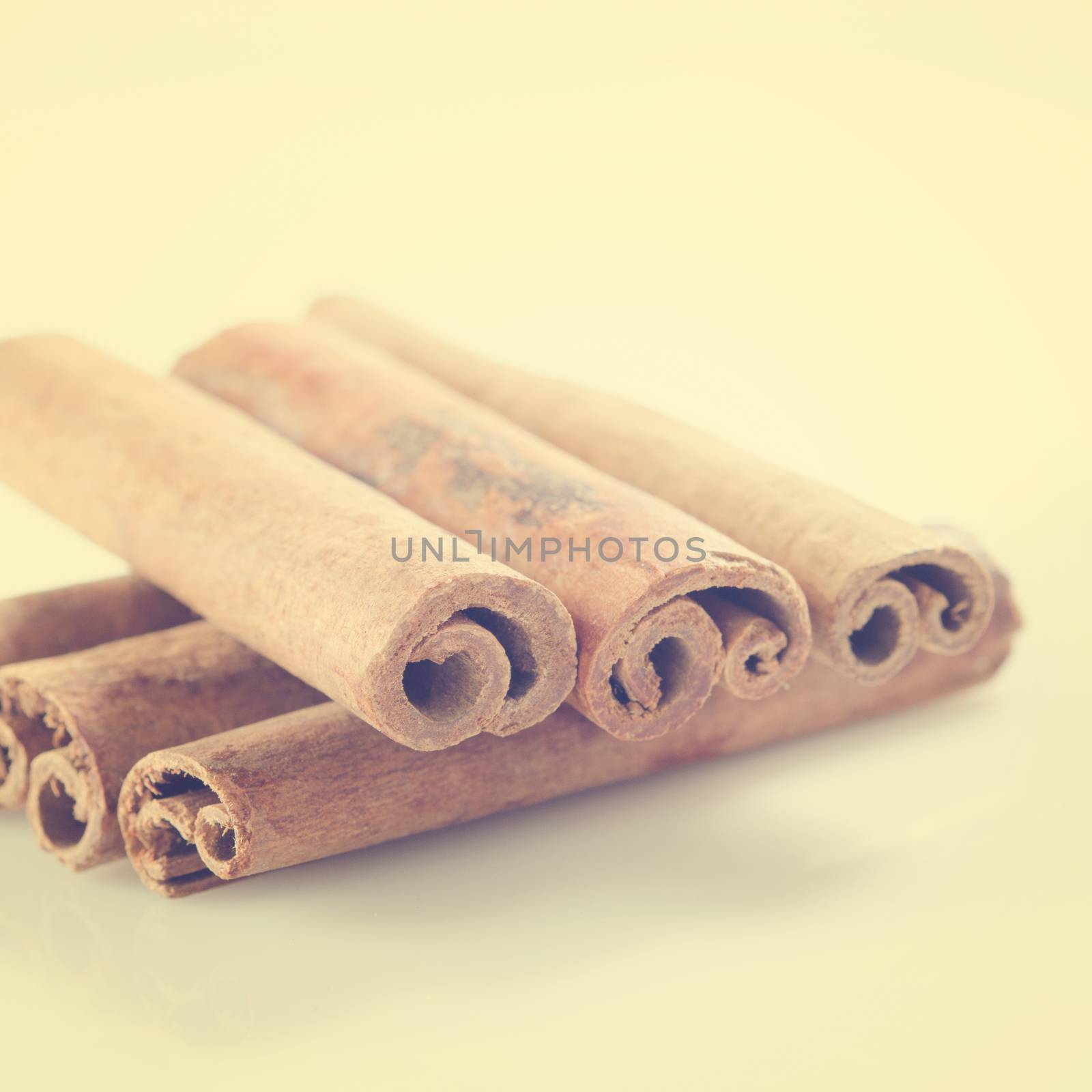 Cinnamon sticks in vintage retro background.