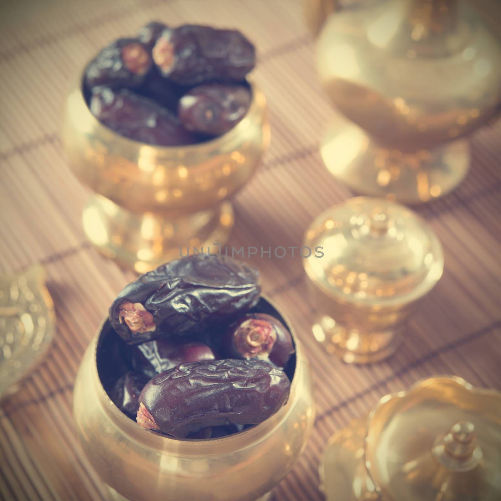 Dried date palm fruits or kurma, ramadan food which eaten in fasting month in retro effect.