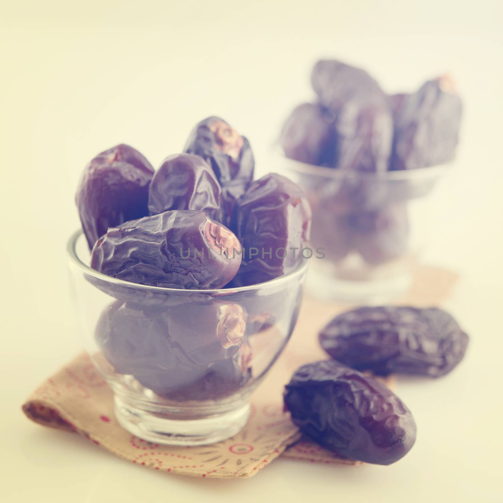 Dried date palm fruits or kurma, ramadan food which eaten in fasting month in vintage retro effect.