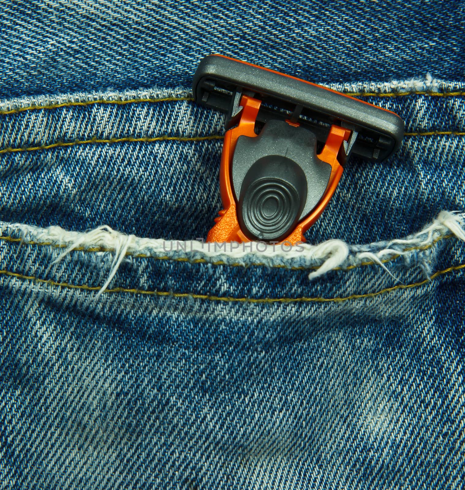 Closeup to jeans pocket with shaving razor