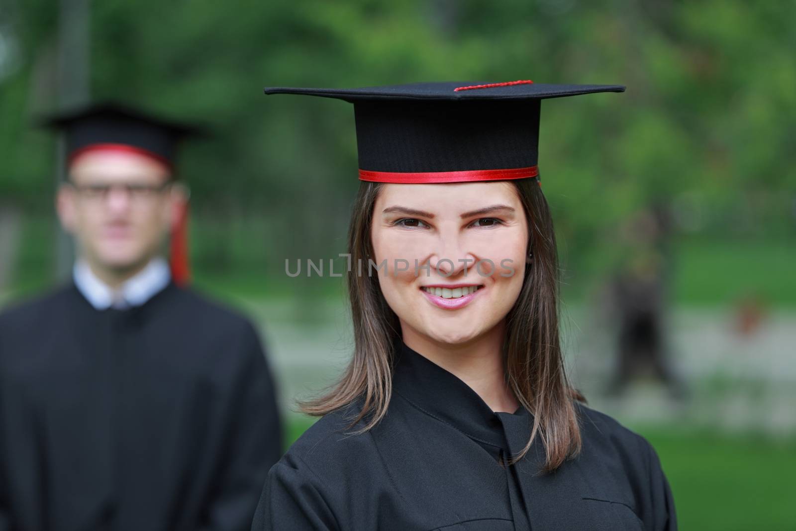 Outdoor portrait of a young student woman in the graduation day.