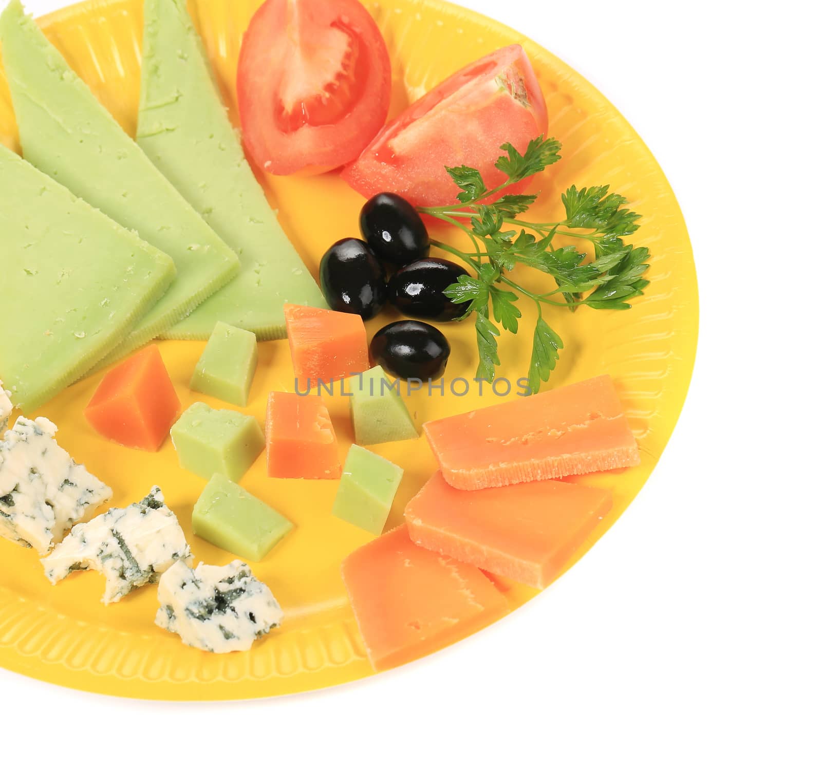Cheeses and vegetables. Isolated on a white background.