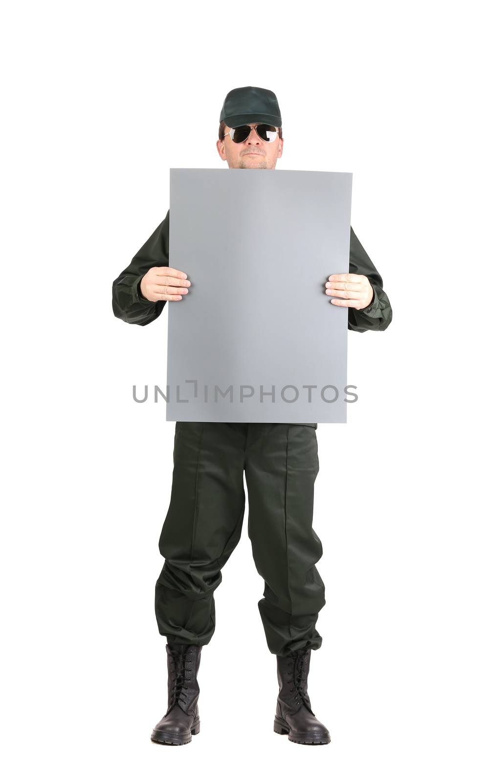 Man in workwear holds paper sheet. Isolated on a white background.