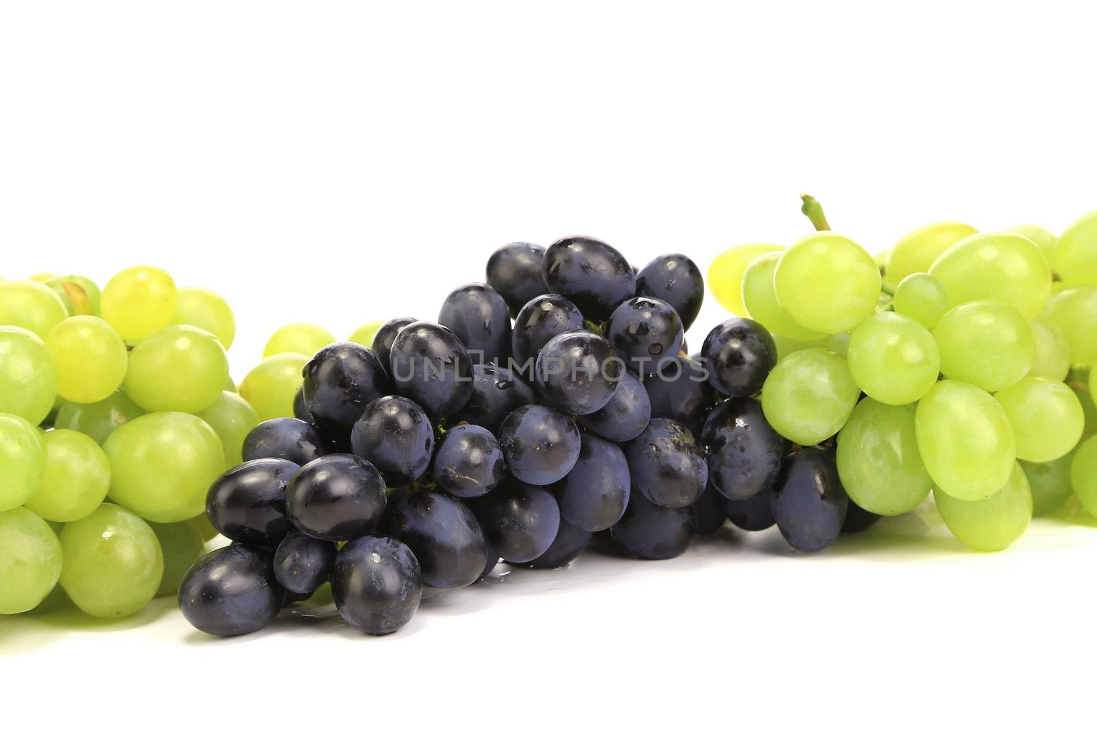 Bunch of ripe green and red grapes. Isolated on a white background.