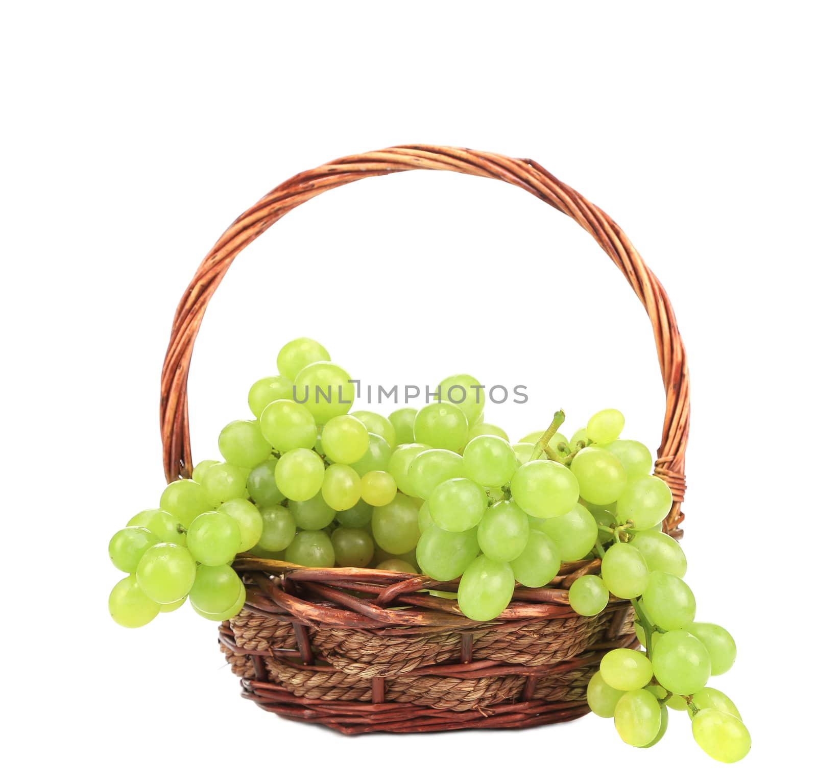 Green grapes in a wicker basket. Isolated on a white background.