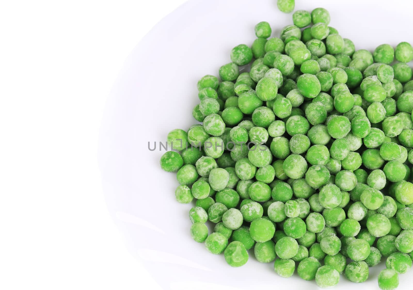 Frozen green peas. Isolated on a white background.